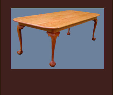 cherry dining table wirh tombstone corners and ball and claw feet