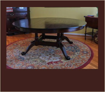 custom circular mahogany dining table with central leaves and figured inlay
