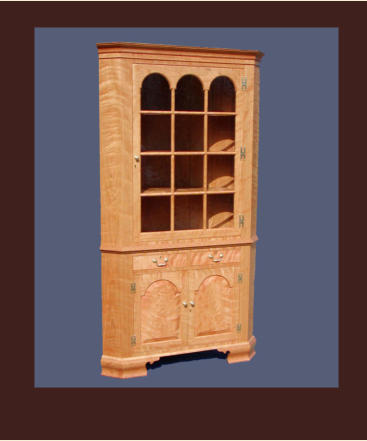 reproduction of a virginia corner cabinet in cherry with tombstone doors and antique glass