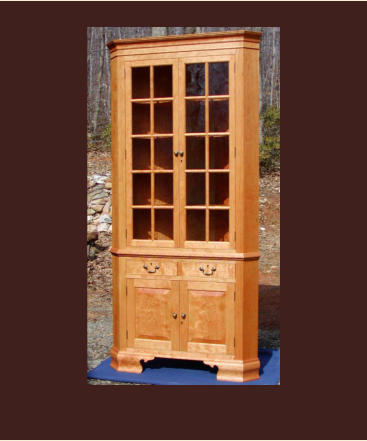 reproduction of a pennsylvania corner cabinet in cherry with drawers and antique glass