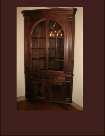 reproduction of a maryland corner cabinet in walnut with drawers and antique glass